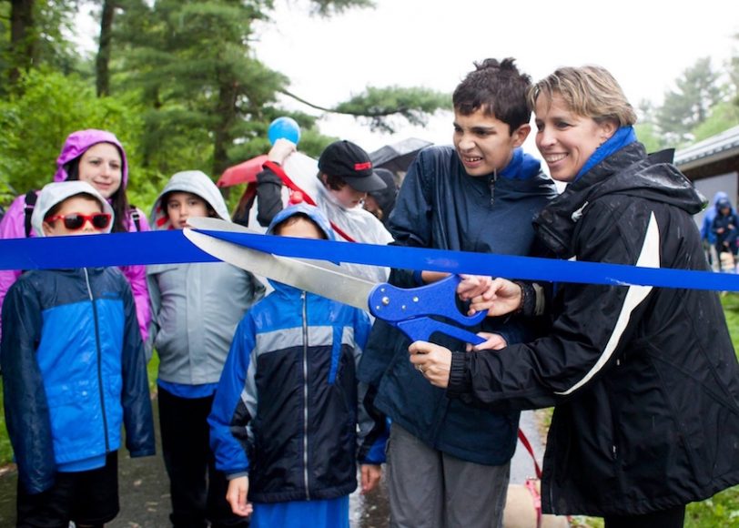 BluePath Board chairman Tricia Zarro and son Danny cut the ribbon to kick off BluePath Service Dogs’ second annual walkathon. Photograph by Samantha Okazaki.