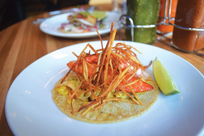 Lobster tacos are topped with potato threads.