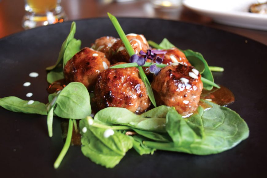 Kobe meatballs on a bed of spinach.