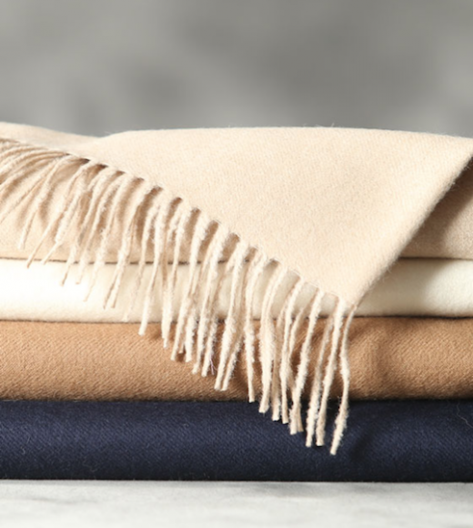 Herde de Ferme’s “Cozy” throws in beige, white, camel and navy.