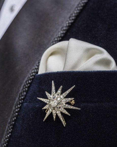 A Victorian diamond 12-ray star brooch from Bentley & Skinner, centered on a 0.65-carat old brilliant-cut diamond (circa 1870). Tailoring by Henry Poole & Co.