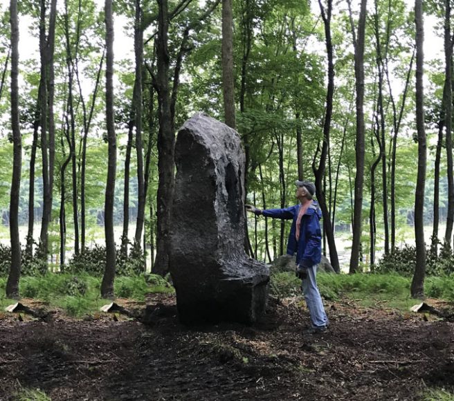 Bob Madden at the carving site with his latest stone sculpture, to be unveiled this month during the 2018 ArtEast Open Studio Tour. Courtesy Bob Madden.