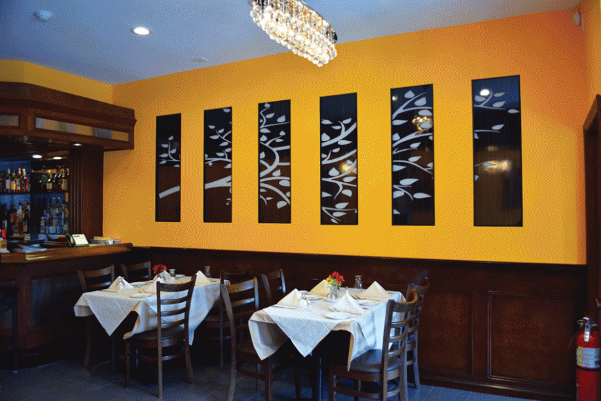 Dark wooden accents, brightly colored walls and artwork distinguish Magno's Grill.