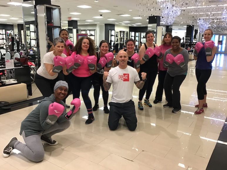 ReCover co-founder Aaron Drogoszewski (kneeling center) showed us how to put up our pink dukes in the third and last class celebrating Breast Cancer Awareness Month at Bloomingdale’s White Plains. That’s WAG editor in chief Georgette Gouveia on the far left.

