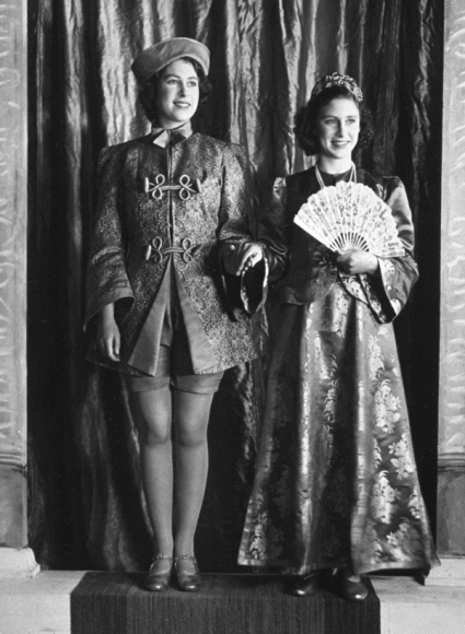 A 1943 gelatin silver photograph of then Princess Elizabeth (now Queen Elizabeth II) and her sister, Princess Margaret, starring in a Windsor Castle production of “Aladdin.” As usual, the sensible, tomboyish Elizabeth, nicknamed Lilibet, was Principal Boy while the romantic, dramatic Margaret, nicknamed Margot, insisted on being the princess (here Princess of China). Courtesy Daily Herald Archive at the National Media Museum, United Kingdom.
