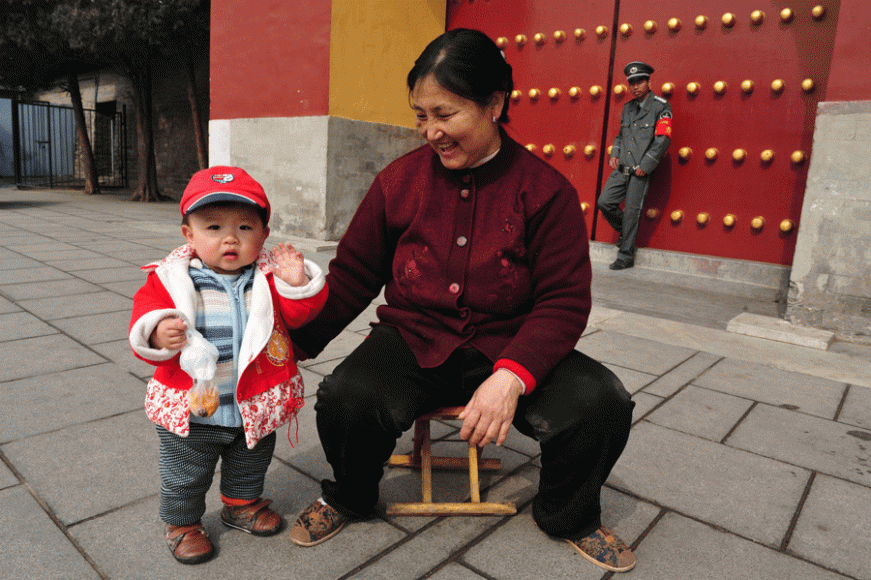 A Chinese woman and child at the entrance gate to the Temple of Heaven Park in Beijing on March 13, 2009. 