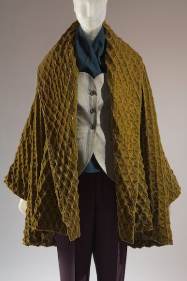 Romeo Gigli, ensemble with coat of faux smocked velvet designed by Nigel Atkinson, fall 1991, Italy. The Museum at FIT. © The Museum at FIT. Courtesy The Museum at FIT.