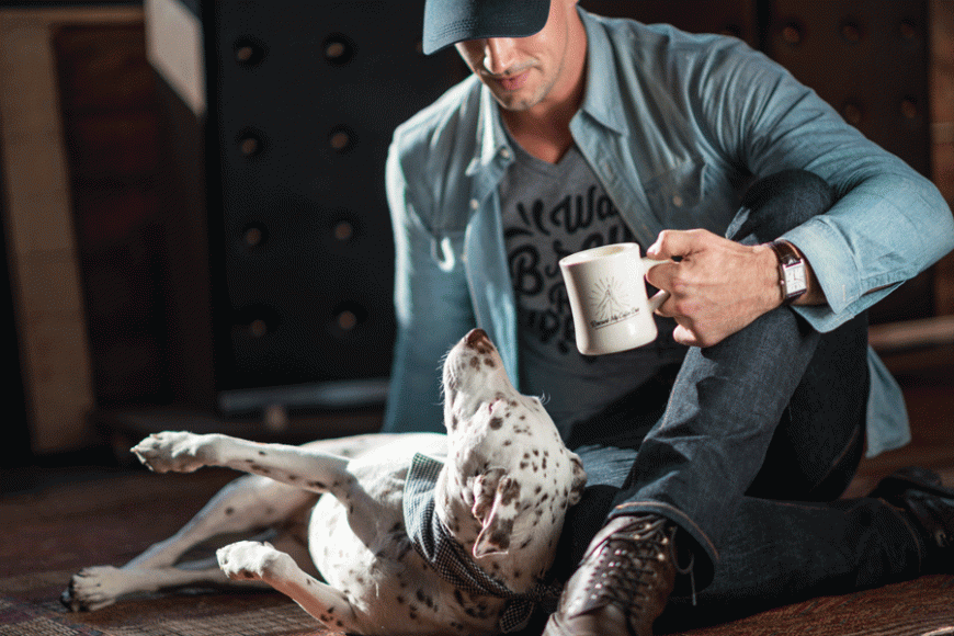 Jordan Karcher, founder of Grounds & Hounds, and his own dog, Molly, the inspiration for the project. 
Courtesy Grounds & Hounds Coffee Co.