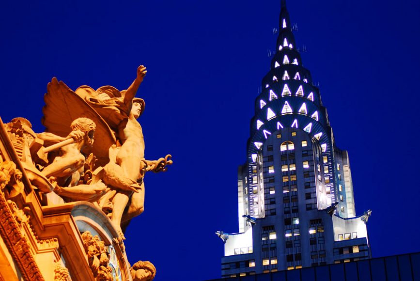 “The way you look tonight” — Two of New York’s dominant architectural styles come together as the beloved Chrysler Building, a paean to Art Deco dreams, watches Mercury, the winged god of commerce, take flight from Grand Central Terminal’s Beaux Arts façade. 