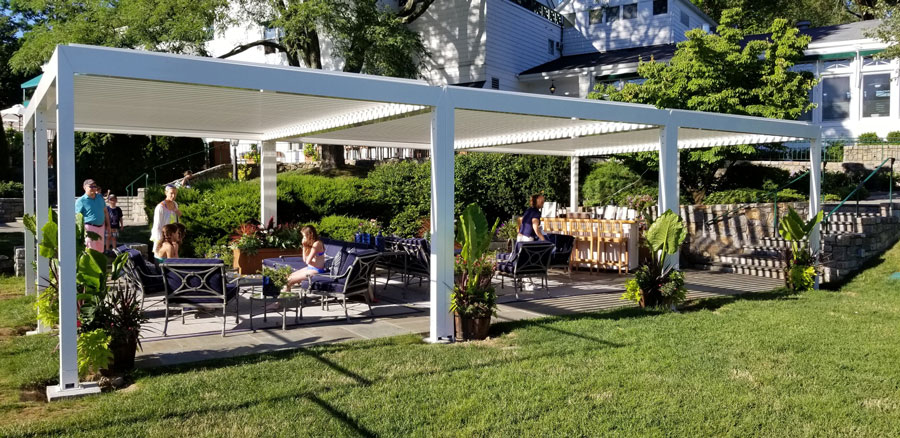 Louvered awnings at this Bronxville property allow the pergola to become completely waterproof at the click of a button. Courtesy Gregory Sahagian & Son.