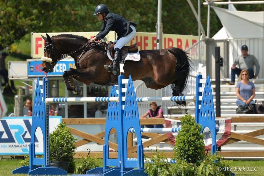 Leslie Howard soars to victory with Quadam on the final day of competition at Old Salem Farm’s Spring Horse Shows. Photograph by The Book.