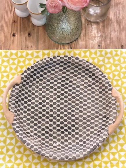 A handled platter from Terrafirma Ceramics makes a modern statement, contrasting elegantly with a Natural Habitat block print tablecloth and a recycled Spanish Glass pitcher. All are available through PORCH Home + Gifts, which has just launched its online store. Courtesy PORCH Home + Gifts.
