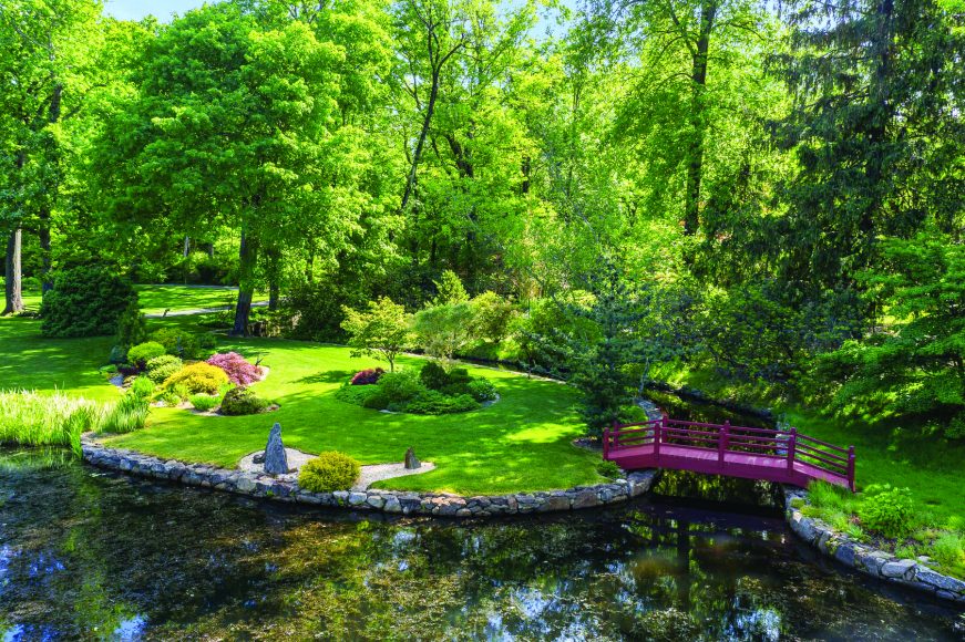 This Tudor-style estate (opposite) – the former home of Michael Bakwin, a supporter of the New York Botanical Garden and the Brooklyn Botanic Garden – features magnificent landscaping, including this Japanese rock garden. Courtesy Daniel Milstein Photography.
