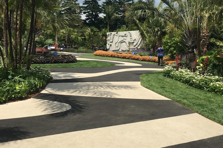 A serpentine mosaic path leads to a water element in the New York Botanical Garden’s “The Living Art of Roberto Burle Marx.” Photograph by Georgette Gouveia.
