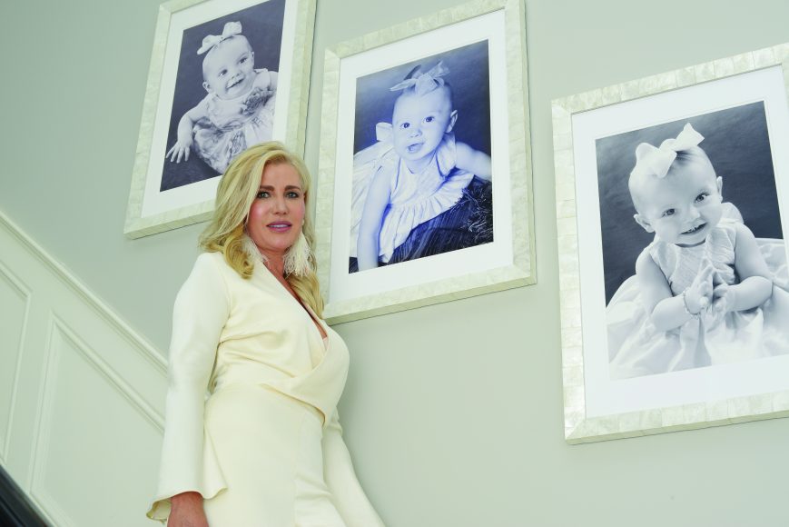 Izabela O’Brien, with photographs of her three daughters.