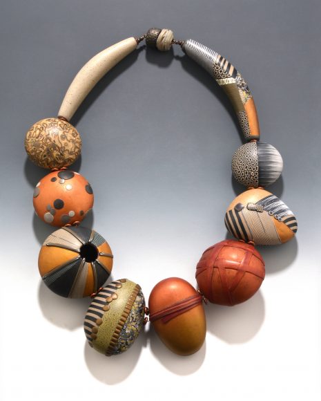 Alberta’s Stepping Stones features 22 inches of hollow beads veneered with patterned polymer sheets, with copper spacer beads and a covered barrel clasp. Photograph by Bob Barrett. Courtesy Loretta Lam.