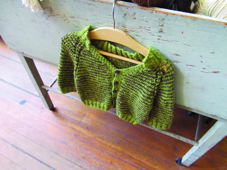 Projects such as this child’s sweater offer inspiration at Flying Fingers Yarn Shop.