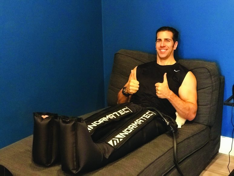 WAG fitness guru Giovanni Roselli using the NormaTec Recovery System. Courtesy Giovanni Roselli.
