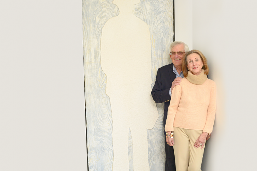 James and Susan Dubin in front of 
“Man With a Suitcase,” mixed media on paper. Photograph by Bob Rozycki.