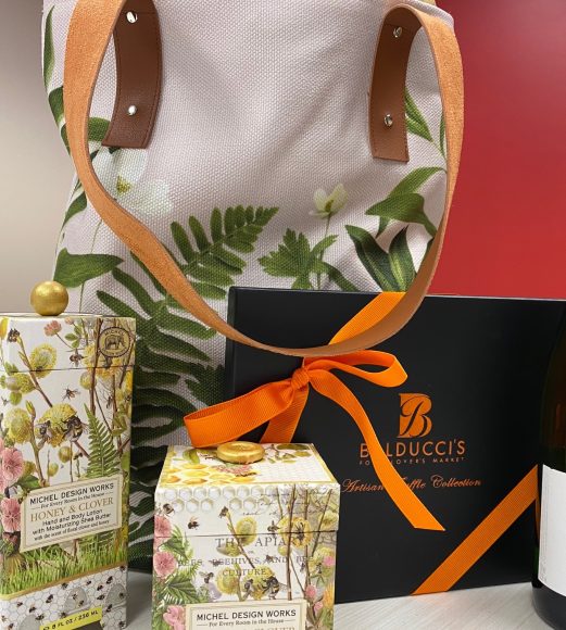 Go Red for Women chair Maureen Adams has filled her one-of-a-kind, hand-painted tote with Balducci’s truffles, Champagne and Honey and Clover hand and body lotion and soy wax candle. Courtesy Go Red for Women.