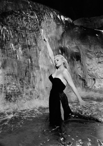 In “La Dolce Vita,” Anita Ekberg revels in Rome’s Trevi Fountain in the iconic strapless black gown that helped earn Piero Gherardi a 1961 Oscar for Best Costume Design (Black-and-White) and made women realize that basic black wasn’t just for mourning. (Audrey Hepburn wearing a black Givenchy gown in the equally iconic opening of “Breakfast at Tiffany’s” the same year would have a similar effect.)  Courtesy The Criterion Collection.