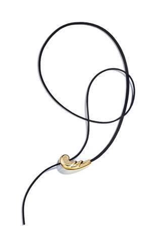 lsa Peretti Whip mini necklace in 18k yellow gold with diamonds and black silk cord, 32 inches. Image courtesy Tiffany & Co.