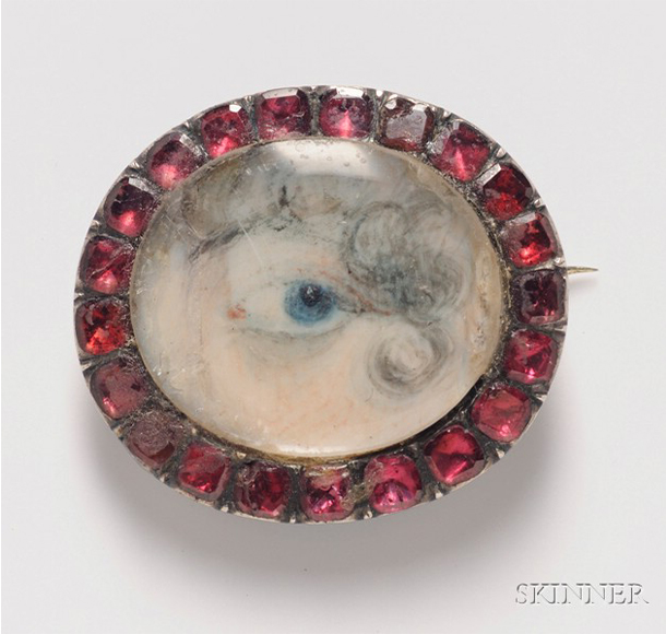 Antique Miniature Eye Portrait Brooch, the portrait depicting a bright blue eye below curling powdered locks, framed by foil-backed red pastes. Sold for $2,370 at Skinner Inc.