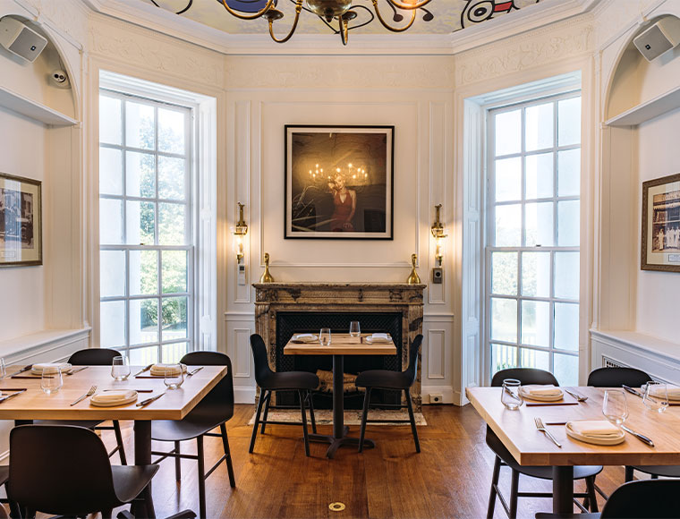 A dining room at Goosefeather features a ceiling that evokes Alexander Calder and Piet Mondrian. Photograph by All Good NYC.