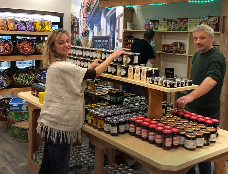 Drew and Leigh Hodgson stacking jars in The Hamlet. Photograph by Jeremy Wayne.