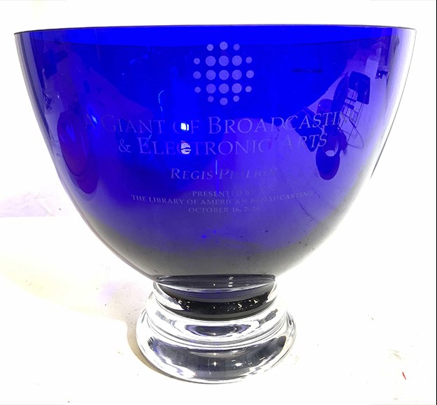 This blue glass award, made in Poland ($200-600), is inscribed “A Giant Of Broadcasting & Electronic Arts, Regis Philbin” and was presented by the Library of American Broadcasting in 2014.
