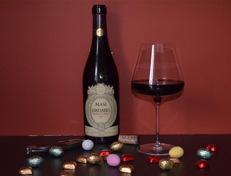 A bottle of 2012 Masi Costasera Amarone Classico surrounded by a selection of chocolates from the Divine Chocolate company.