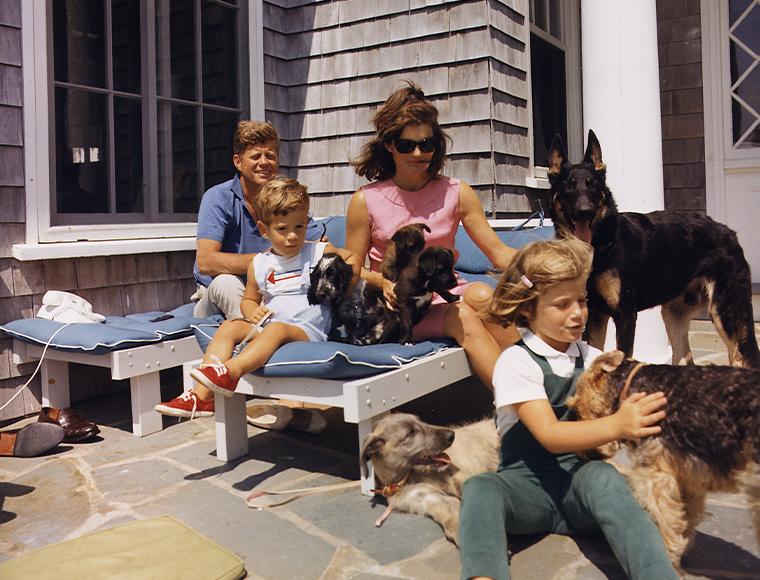 Hyannisport, Massachusetts, Aug. 14, 1963 – President John F. Kennedy, wife Jacqueline, son John Jr. and daughter Caroline with their dogs Clipper (standing), Charlie (with Caroline), Wolf (reclining), Shannon (with John Jr.) and two puppies from Pushinka, who was a gift from Soviet Premier Nikita Khrushchev. Cecil Stoughton 
White House Photographs.