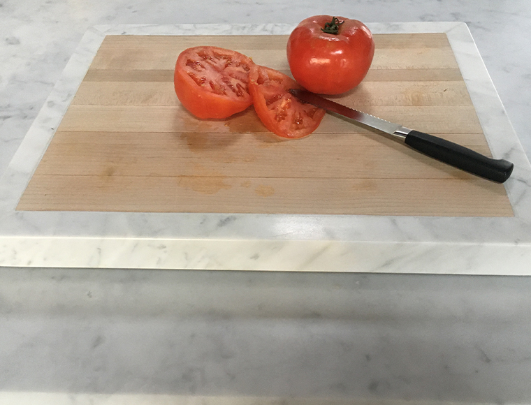 A cutting board by Oscar Reyes (left) of Westchester Marble and Granite Works promises to usher in a new line of kitchen essentials from the company, including cheeseboards, trivets and spoon rests.