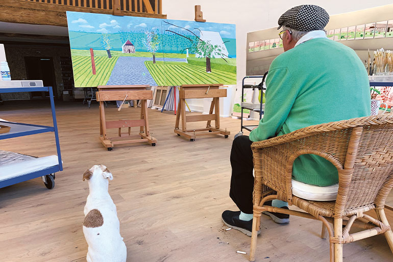 David Hockney and his dog Ruby in the artist’s Normandy studio, May 25,2020. Copyright David Hockney. Photograph by Jean-Pierre Gonçalves de Lima.