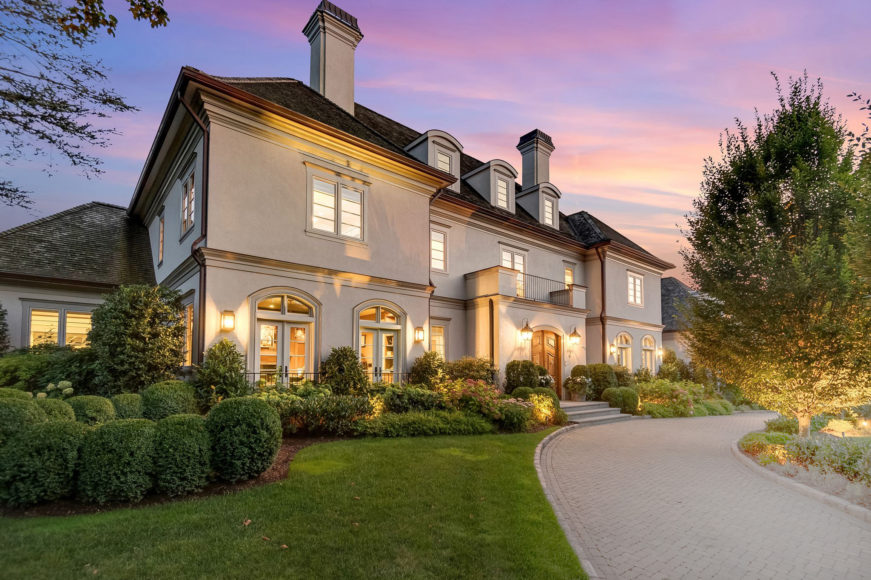 4 Fordal Road, Bronxville, a Houlihan Lawrence property, gleams beneath a pastel sky.