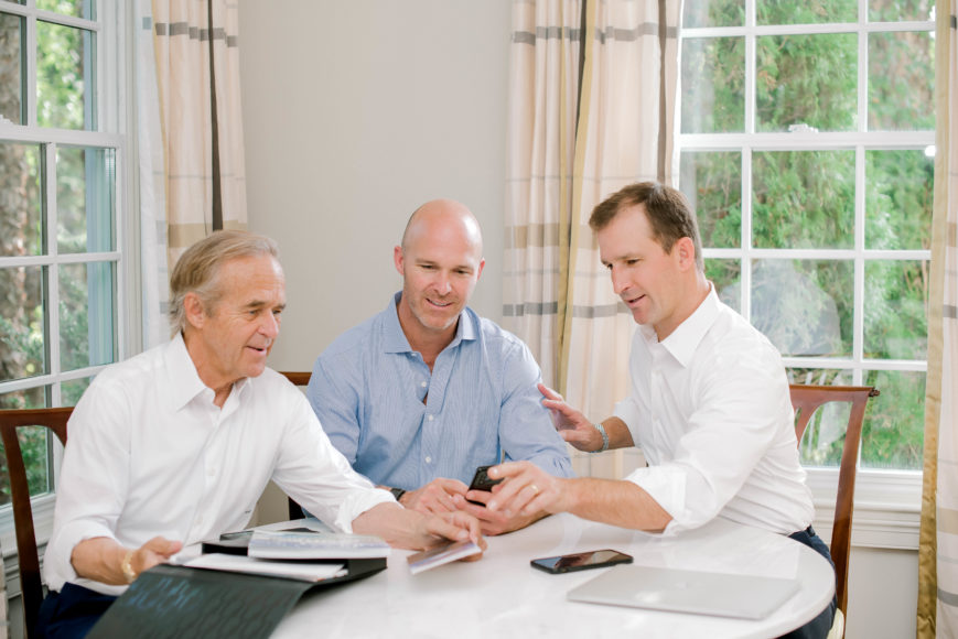 Family affair: From left, William Raveis, founding chairman and CEO, William Raveis Real Estate, Mortgage & Insurance; son Chris, president of Residential Sales for William Raveis Real Estate and Affiliates, co-president of William Raveis Inc. and corporate secretary of William Raveis Inc.; and son Ryan, co-president of William Raveis Real Estate and president of William Raveis Mortgage. 
Courtesy Mindy Briar Photography.