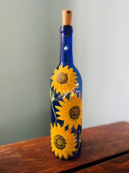 Aquila’s Nest Vineyards in Newtown, Connecticut, hosts a fundraiser for Ukraine in which you’ll learn how to paint its national flower, the sunflower, on a blue wine bottle. Courtesy Aquila’s Nest Vineyards. 