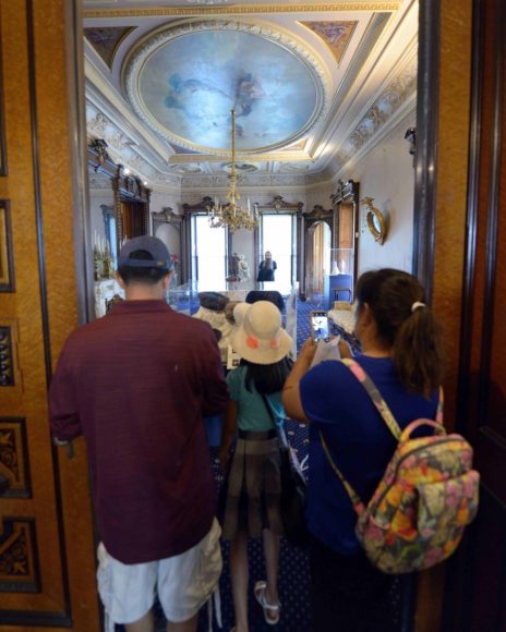 A young visitor and her family snap a photo of The Lockwood-Mathews Mansion Museum’s Drawing Room in 2019. The manse is considered a classic example of Second Empire style, which flourished in the United States in the decades bracketing the Civil War. Courtesy Gus Apazidis. 
